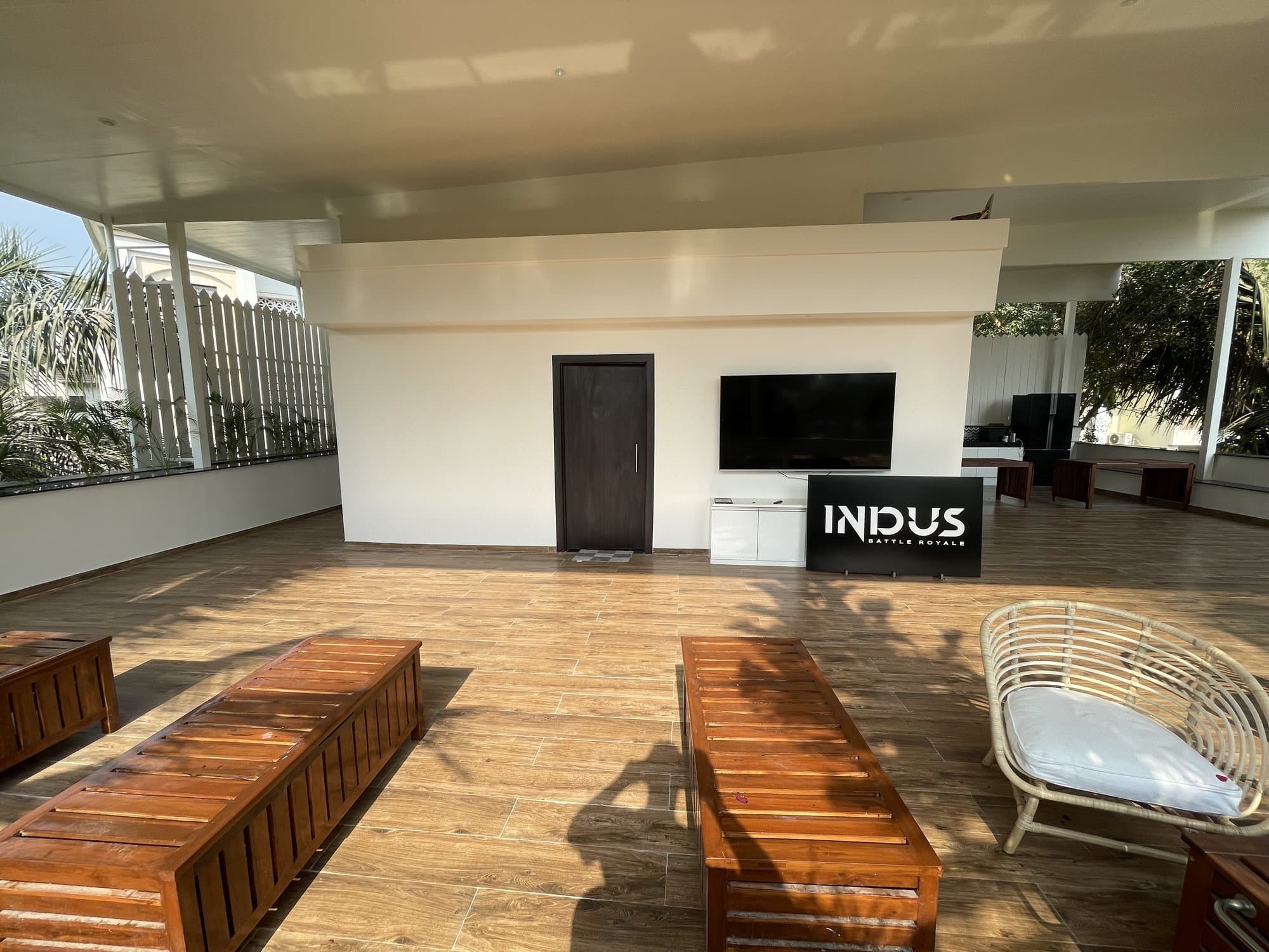 The transformed terrace, fitted out as a covered lounge and recreation area with a TV and seating